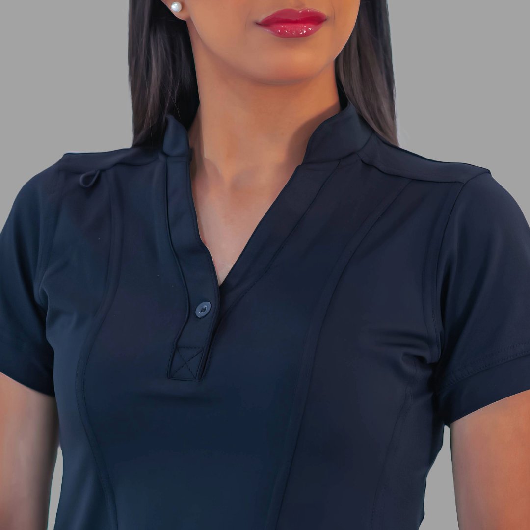 Close-up detail of the split neckline and front button on the navy blue Style 930 scrub top.